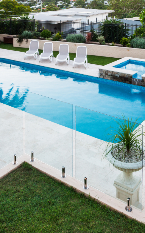 Glass fence pool view with sunbeds